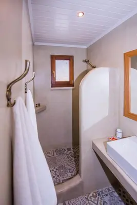 a bathroom with a shower and a sink and towels at Lardas Luxury Country House in Kissamos