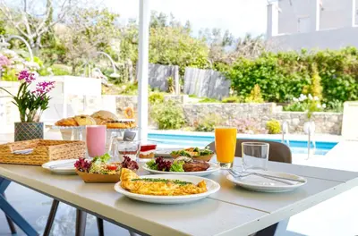 a table with plates of food and drinks on it at Villa Agrithea in Kissamos
