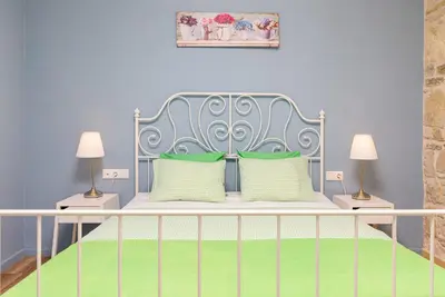 a bedroom with a blue bed with two lamps at Villa Agrithea in Kissamos