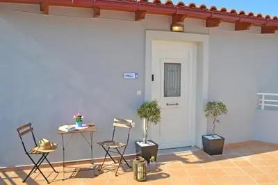 a room with two chairs and a white door at Mare Civitas Apartments in Chania Town
