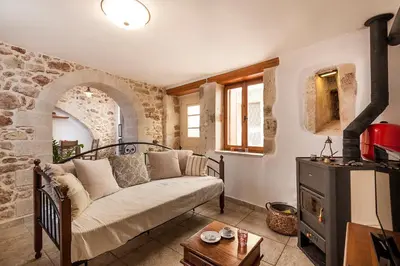a living room with a couch and a stove at Casa Eleni in Chania Town