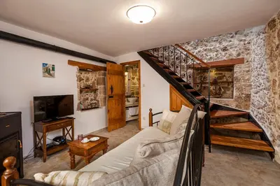 a living room with a couch and a staircase at Casa Eleni in Chania Town