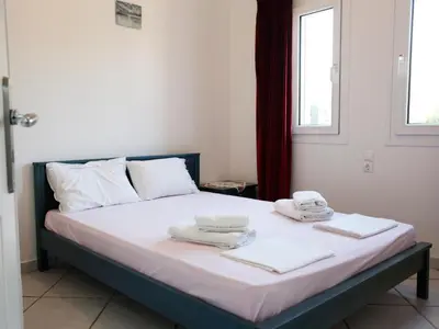a bedroom with a bed with towels on it at Villa-Jasmin in Kato Daratso