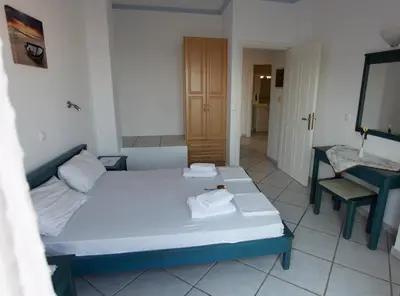 a bedroom with a bed and a sink and a mirror at Villa-Jasmin in Kato Daratso