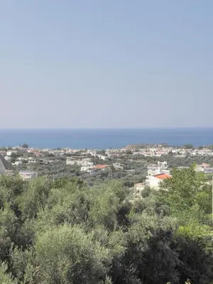 a view of a city with the ocean in the background at Villa-Jasmin in Kato Daratso