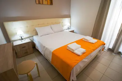 a bedroom with a bed with two towels on it at Naiades Luxury Apartments in Kalathas