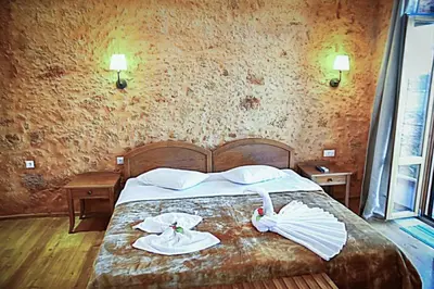 a bedroom with a bed with towels on it at Santrivani Rooms in Chania Town