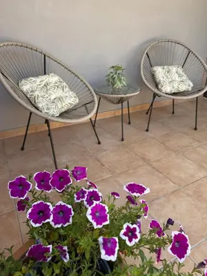 two chairs and a table and some purple flowers at Villa Fanouris in Chania Town