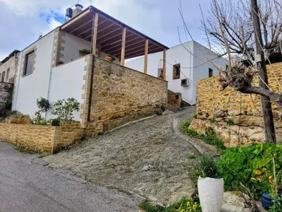 a house with a stone wall at Fudulis Villa in Ravdhoúkha