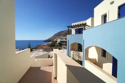 a view of the ocean from between two buildings at Sfakian Horizon in Khóra Sfakíon