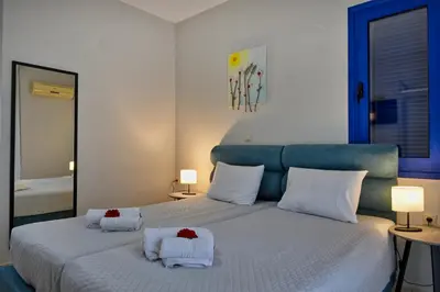 a bedroom with a large bed with two white towels at Sfakian Horizon in Khóra Sfakíon