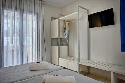 a bedroom with a bed with a mirror and a tv at Sfakian Horizon in Khóra Sfakíon