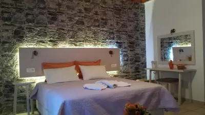 a bedroom with a bed with two towels on it at Loutro Holidays in Loutro