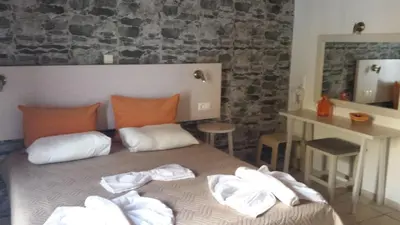 a bedroom with a bed with towels on it at Loutro Holidays in Loutro