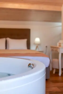 a bee sitting on the edge of a bed at Hamam Suites Portou in Chania Town