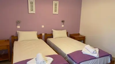 a room with two beds with towels on them at Blue Sky in Palaiochóra