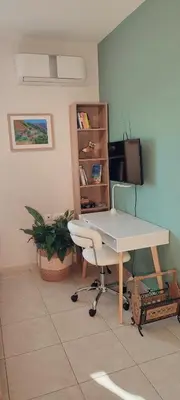 a white desk and a chair in a room at The Garden of Zephyrus - West in Kounoupidhianá