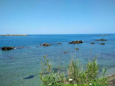 a large body of water with rocks in it at Beloni Apartments and Studios in Chania Town