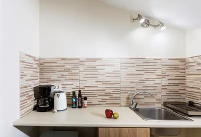 a kitchen with a sink and a counter with apples on it at Kd's - Apartment in Chania Town
