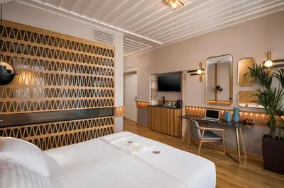 a bedroom with a bed and a desk and a mirror at Scala de Faro in Chania Town