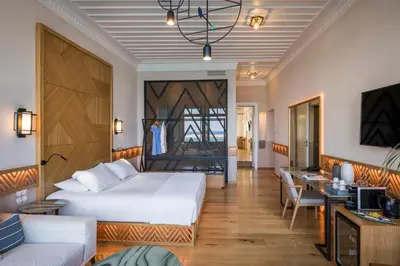 a hotel room with a bed and a living room at Scala de Faro in Chania Town