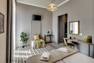 a bedroom with a bed and a desk and a chair at Mosaic in Chania Town