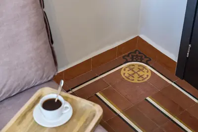 a cup of coffee on a tray on a floor at Mosaic in Chania Town