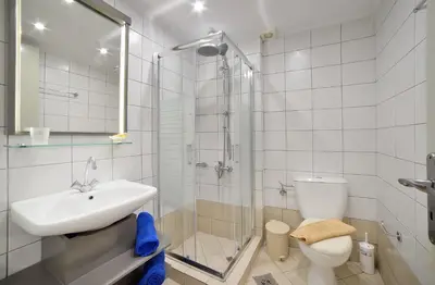 a bathroom with a sink and a toilet and a shower at Mythos- Platanias- Hotel -Apts in Plataniás