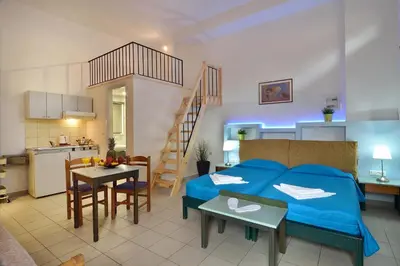 a room with a bed and a kitchen and a room with a kitchen at Mythos- Platanias- Hotel -Apts in Plataniás