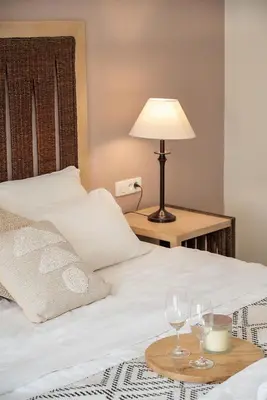 a bed with two wine glasses on a table at Vranas Ambiance Hotel in Chania Town