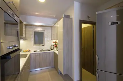 a small kitchen with a sink and a refrigerator at Enali Villas in Kissamos