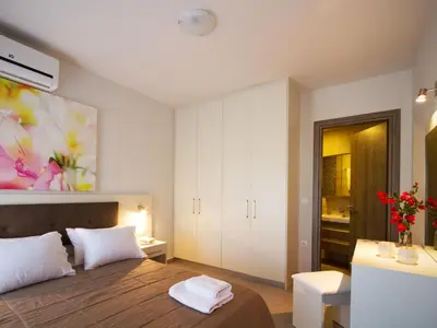 a bedroom with a bed and a painting on the wall at Enali Villas in Kissamos