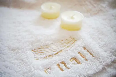 two candles sitting on top of a towel with snow at Enali Villas in Kissamos