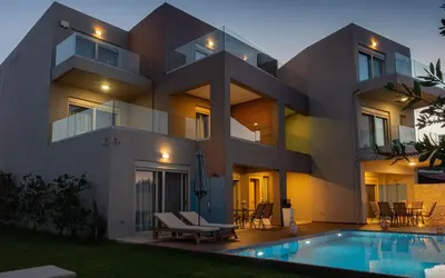 a house with a swimming pool in front of it at Enali Villas in Kissamos