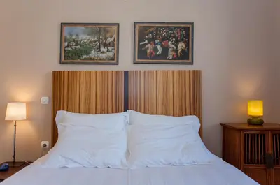 a bedroom with a bed with two pictures on the wall at Spolia Art Maison in Chania Town