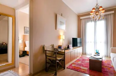 a room with a desk with a chair and a television at Spolia Art Maison in Chania Town