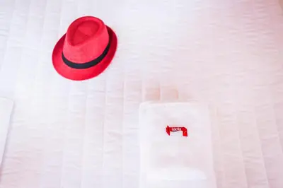 a red hat on a white shirt with a napkin at TheJoy City Suites in Chania Town