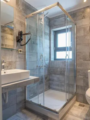 a bathroom with a shower and a sink at Romantic Corner Maisonette houses in Stalos