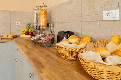 two baskets of bread on a counter in a kitchen at Theos Village Apartments in Kato Daratso