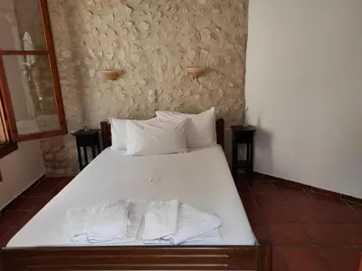 a bedroom with a bed with two towels on it at Potoula Apts in Kato Daratso