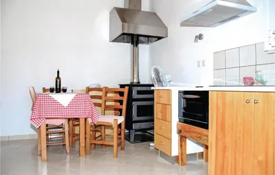 a kitchen with a table and chairs and a stove at Amazing Home In Malaxa, Chania in Maláxa