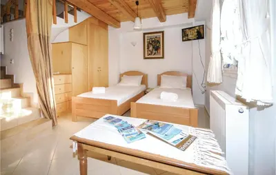 a room with two beds and a table at Amazing Home In Malaxa, Chania in Maláxa
