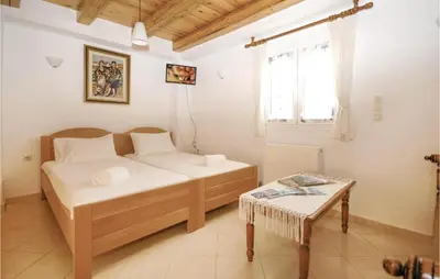 a small bedroom with a bed and a table at Amazing Home In Malaxa, Chania in Maláxa