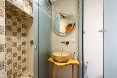 a bathroom with a sink and a mirror at Belmondo Hotel in Chania Town