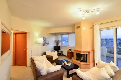 a living room with a couch and a fireplace at Elia Selinou in Chania Town