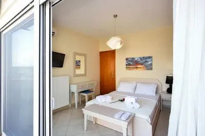 a hotel room with a bed and a window at Elia Selinou in Chania Town