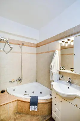 a bathroom with a tub and a sink at Elia Selinou in Chania Town