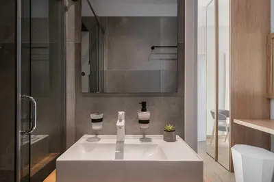 a bathroom with a sink with two wine glasses at Elia Penthouse in Chania Town
