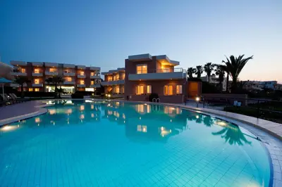 a large swimming pool in front of a building at Phaedra Hotel in Stalos