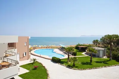an aerial view of a resort with a swimming pool and the ocean at Phaedra Hotel in Stalos